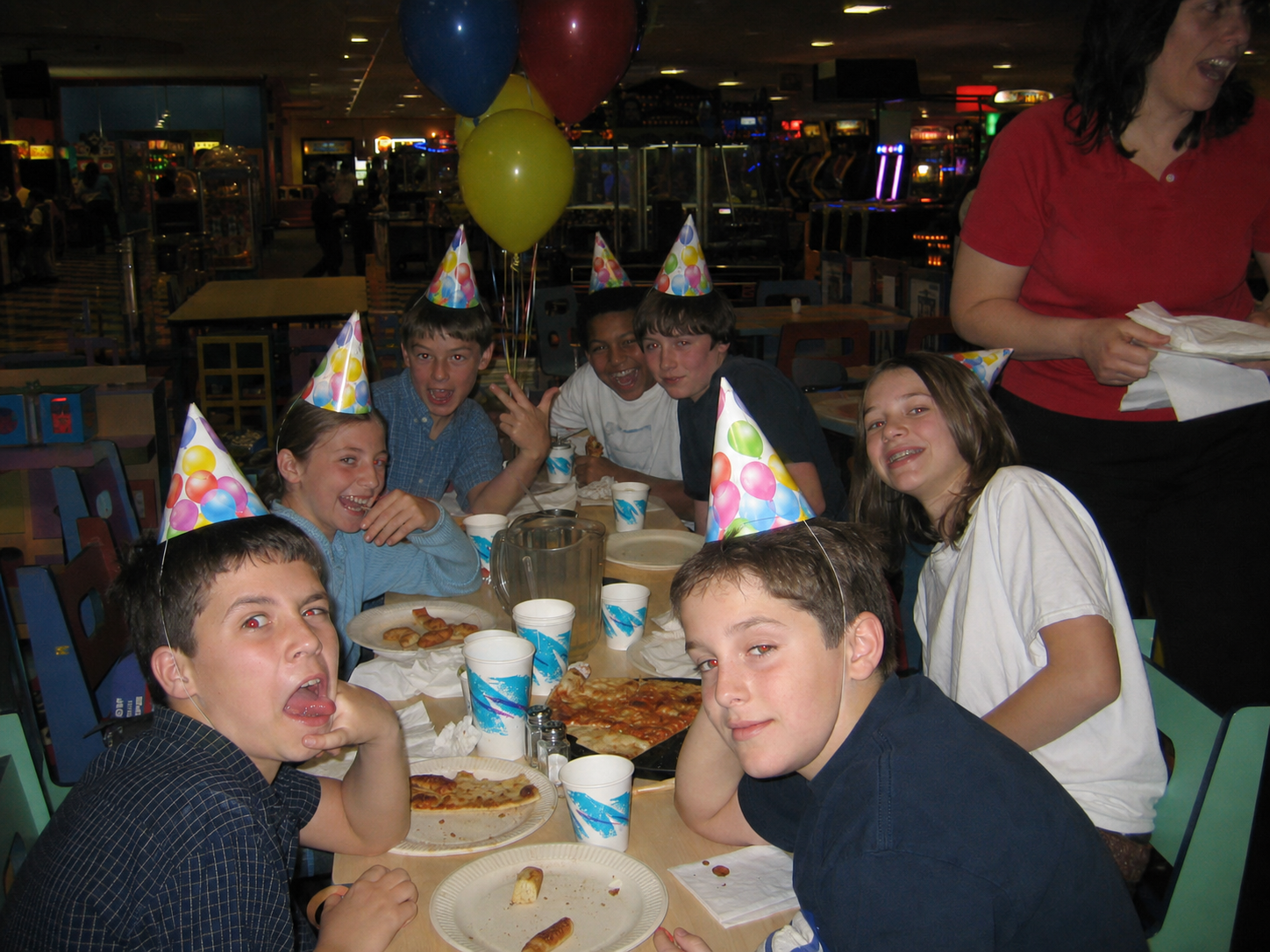 A birthday party around a table inside the arcade